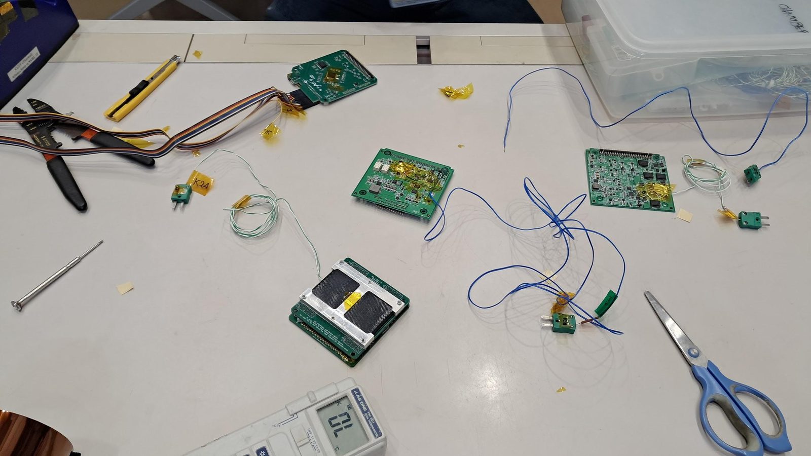 Mesa de trabajo del laboratorio con placas, cableado y herramientas durante la campaña de integración.